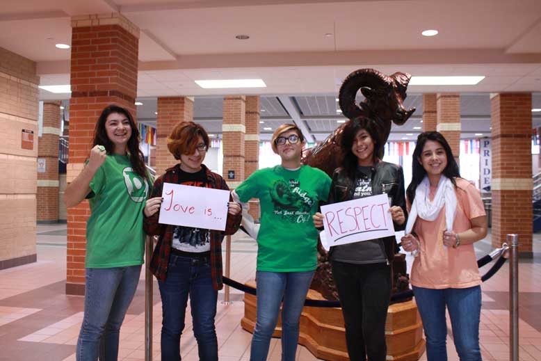 The newspaper staff shows off their pride for Love is Respect week.