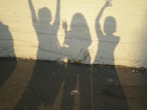 Shadow of teens on wall