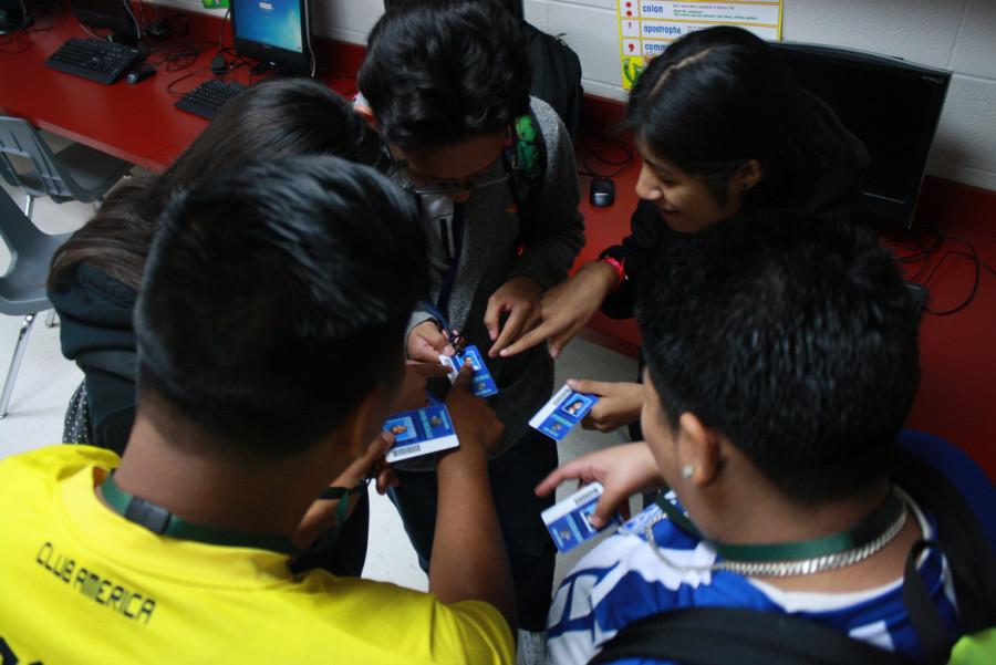 PACE students compare ID badge pictures. These five friends received their badges in the previous period.