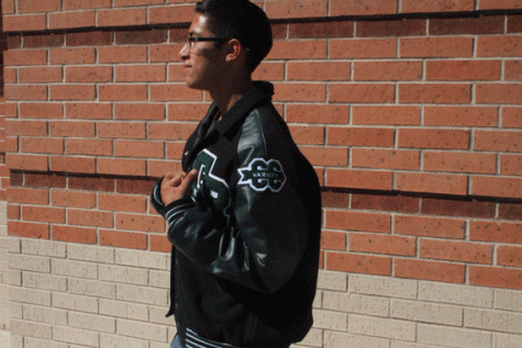 Antonio Lujan showing off his letterman with his varsity cross country patch. 