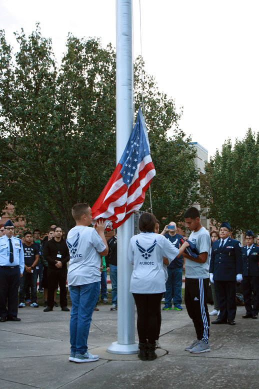 AF-ROTC Color Guard members raise the flags in honor of US veterans and service members.