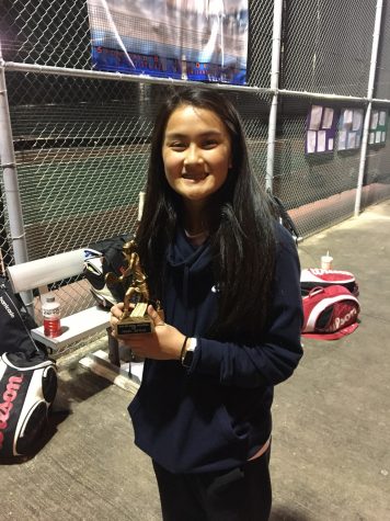 Kaitlyn Nguyen shows off her gold medal after tennis tournament.