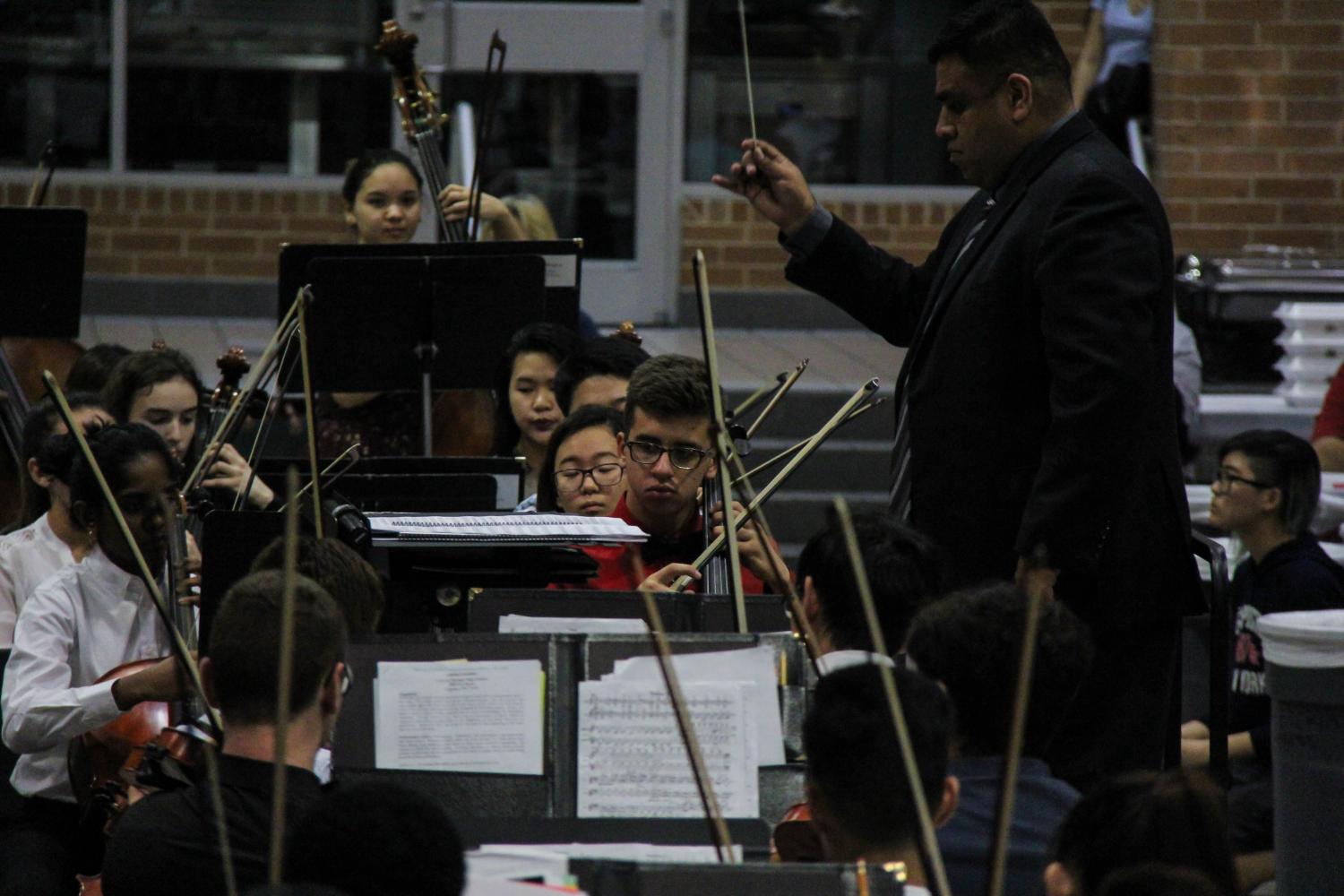 Director of Bands Armando Robledo conducts the Symphony Orchestra. 