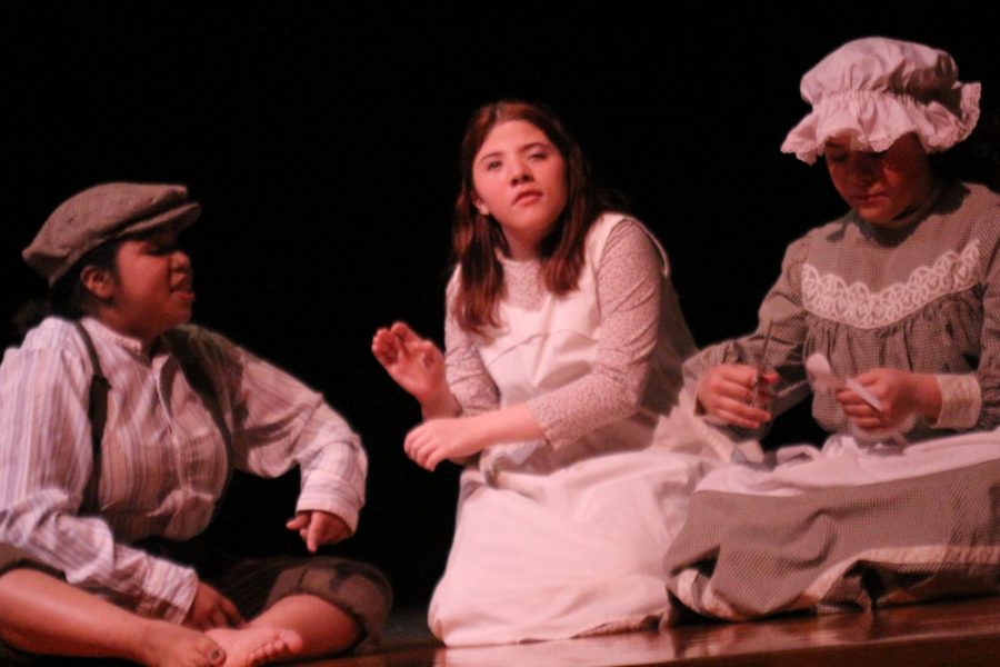 "Helen Keller" playing with other children on stage floor. Actresses names from left to right; Michelle Guerrero, Victoria Goehring