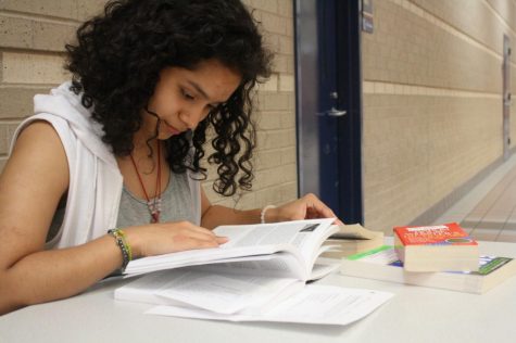 Junior Jimena Jimenez reads her textbook in order to acquire good grades in her classes