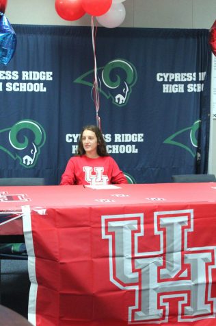 Rachel Garant signs to University of Houston while surrounded by her teammates,friends, and family that showed their support.