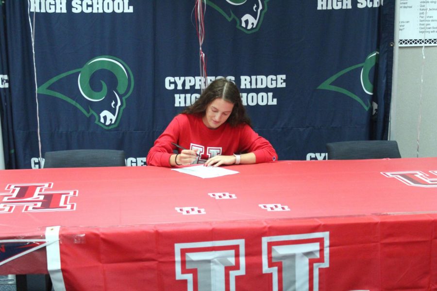 Rachel Garant signs to University of Houston while surrounded by her teammates,friends, and family that showed their support.